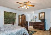 At the far end of the bedroom is the master bath with a spacious vanity area