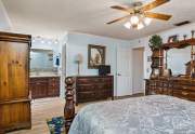 At the far end of the bedroom is the master bath with a spacious vanity area