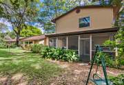 The screened-in back patio provides a peaceful place to enjoy the beautiful yard and outdoors